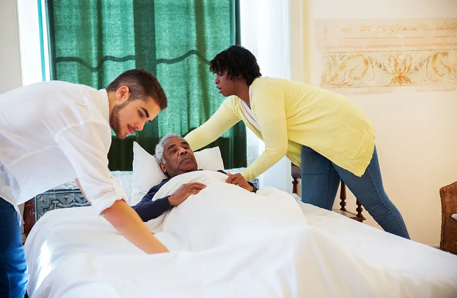 Caregivers Taking Care of Elder Man